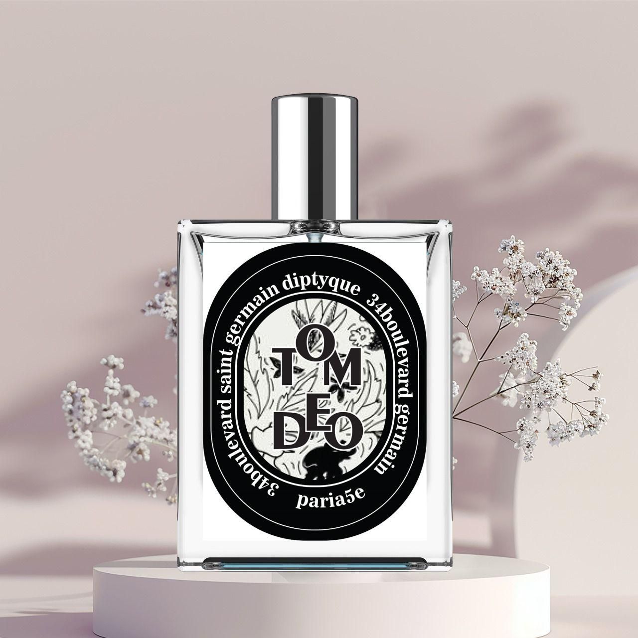 Diptyque perfume bottle with floral decorations on a light background